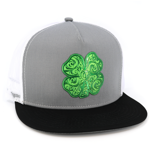 Trebol Black/Grey/White flat visor hat with green ornate four-leaf clover emblem.