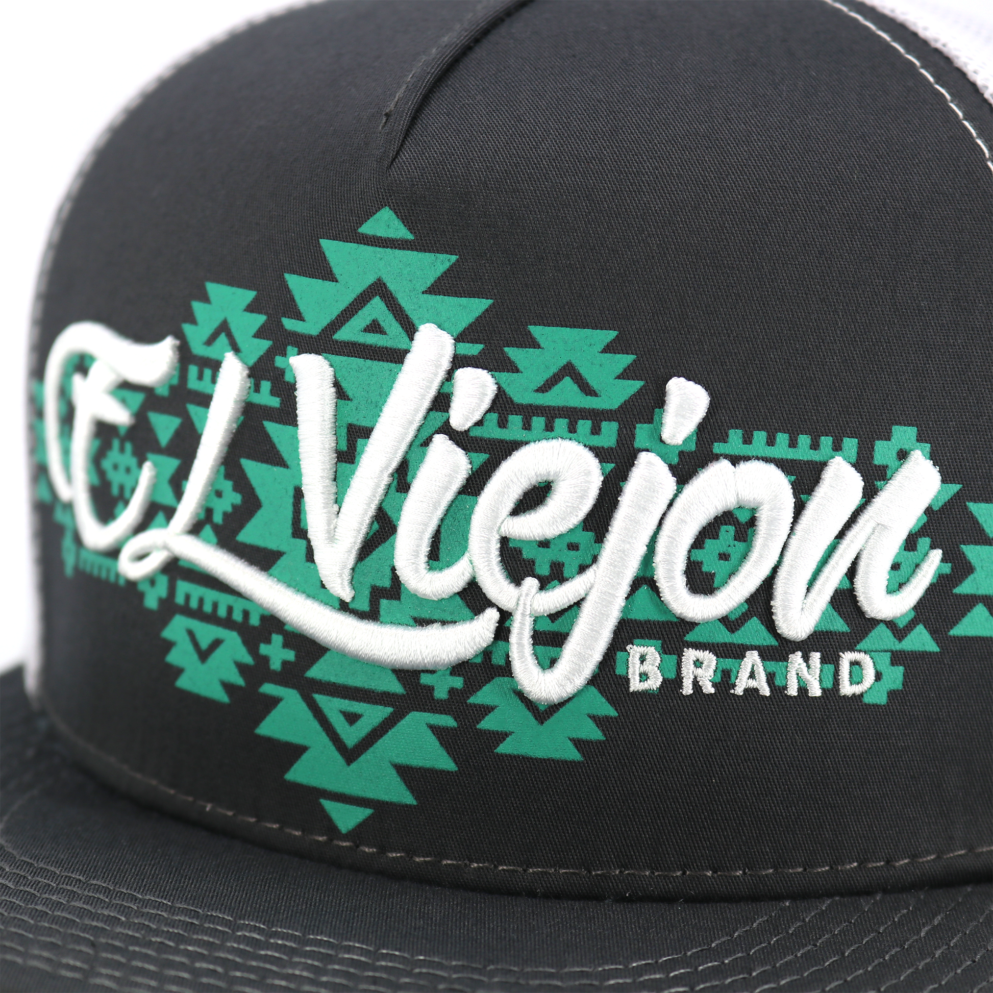 Yucca Charcoal/White flat visor hat with "El Viejon Brand" embroidered in white over a green geometric pattern.