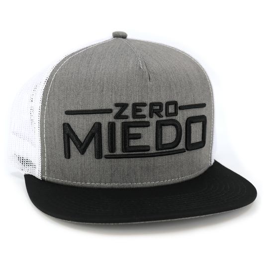 Zero Miedo black/heather/white flat visor hat with black embroidered text, white mesh, and snapback.