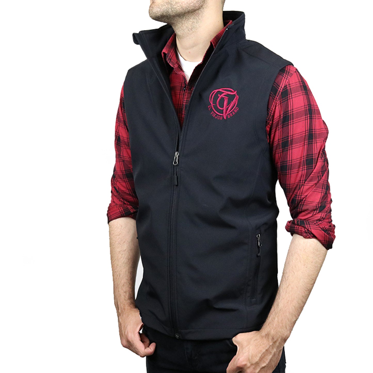 Black El Viejon Brand Vest with maroon logo, zip-through collar, and front pockets, worn over a red plaid shirt.