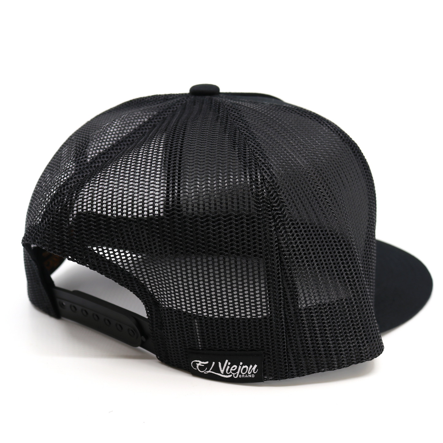 Cachas De Oro Black Visera Plana trucker hat with black mesh back and adjustable snapback.