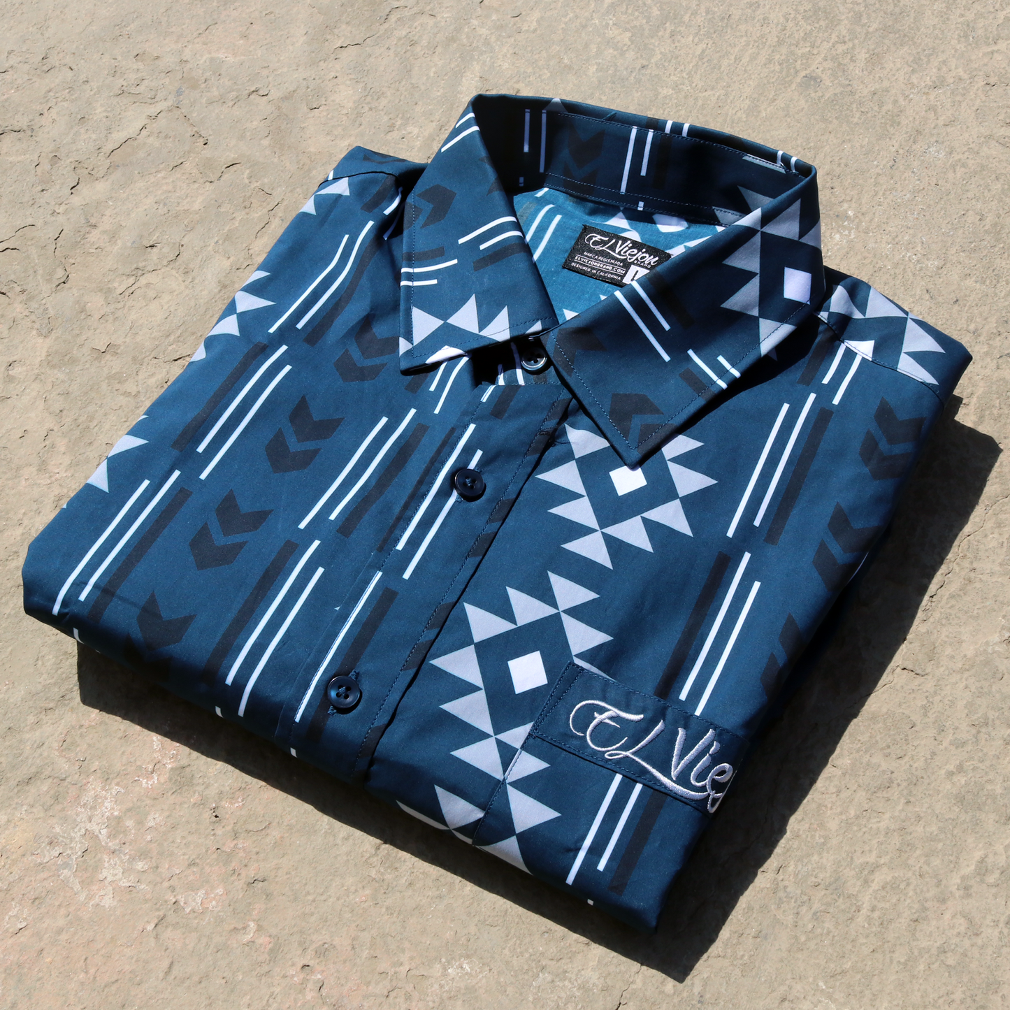 Sonora Navy dress shirt with geometric pattern, long sleeves, straight collar, front pocket, and "El Viejon Brand" logo.
