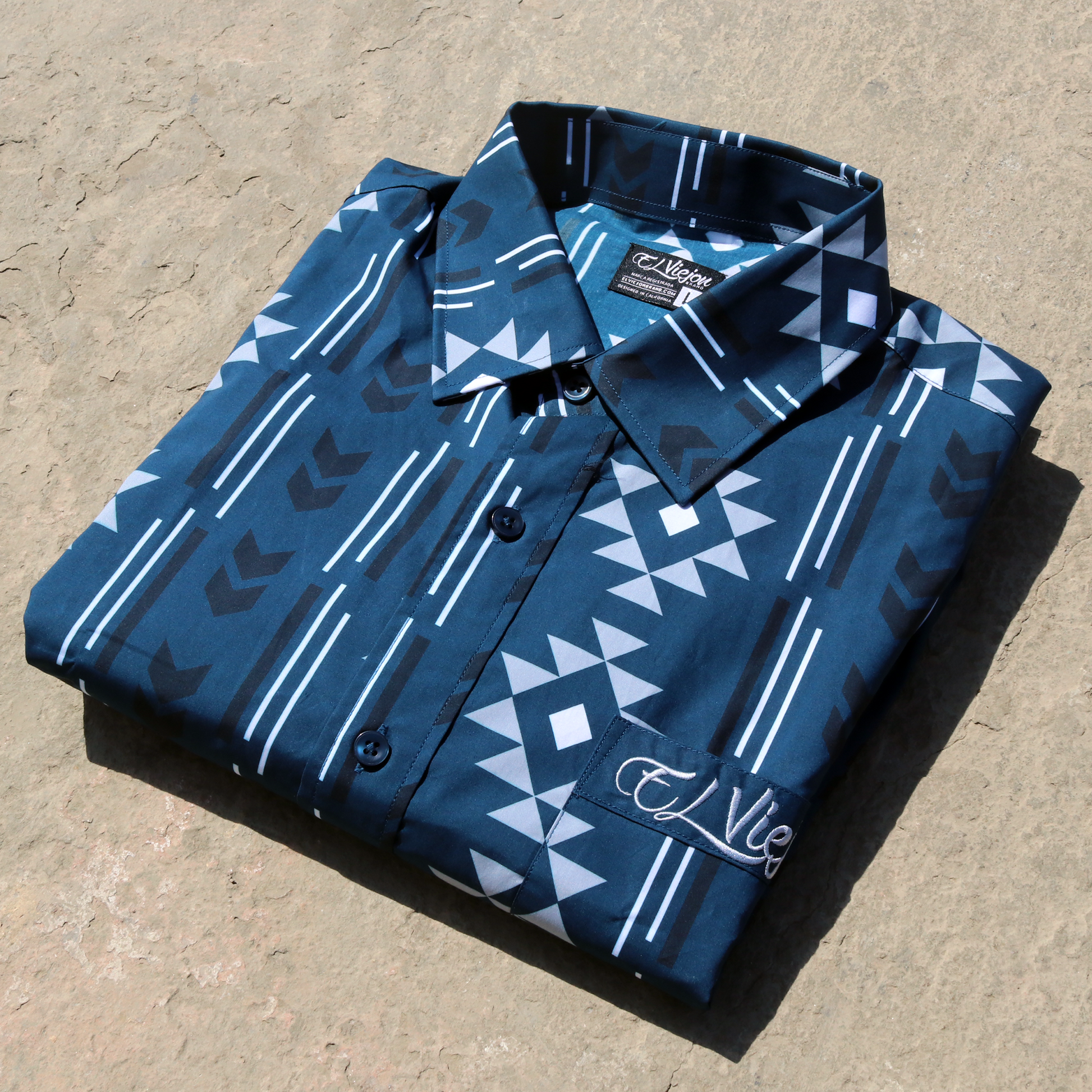 Sonora Navy dress shirt with geometric pattern, long sleeves, straight collar, front pocket, and "El Viejon Brand" logo.