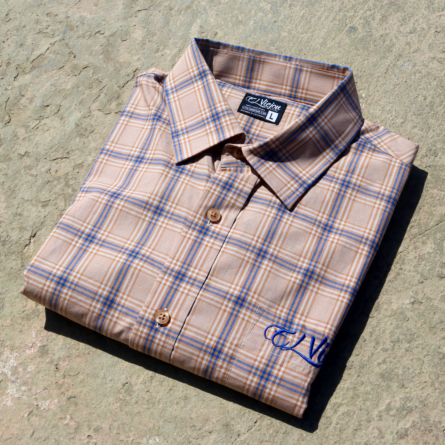 Plaid khaki, tan, and blue dress shirt with straight collar, front pocket, and embroidered El Viejon logo.