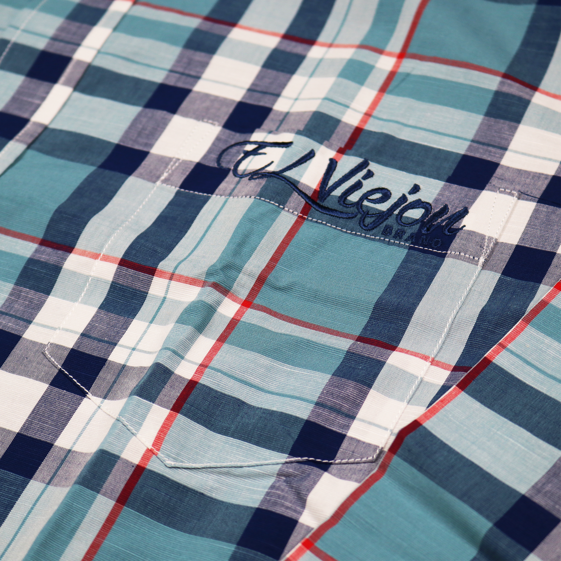 Plaid teal, navy, and red dress shirt with a front pocket and embroidered "El Viejon Brand" logo.
