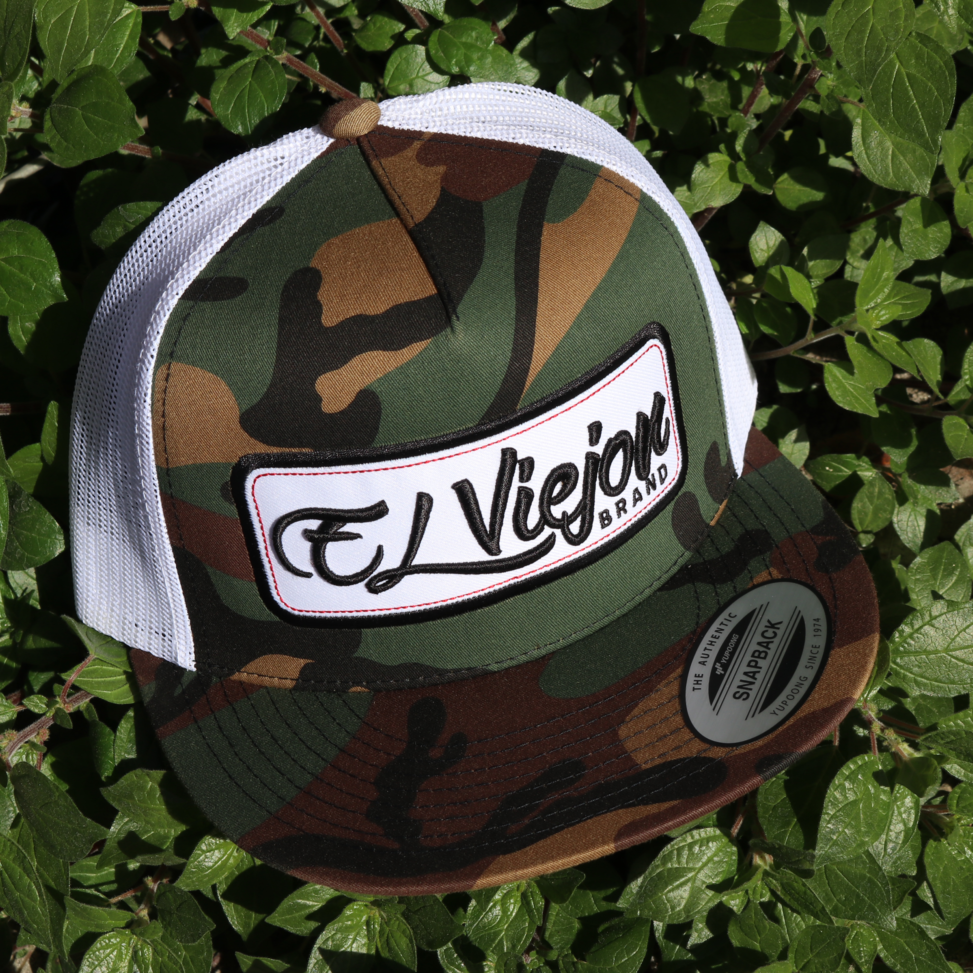 EVPatch Camo/White Yupoong Classic trucker hat with flat visor and "El Viejon Brand" patch.