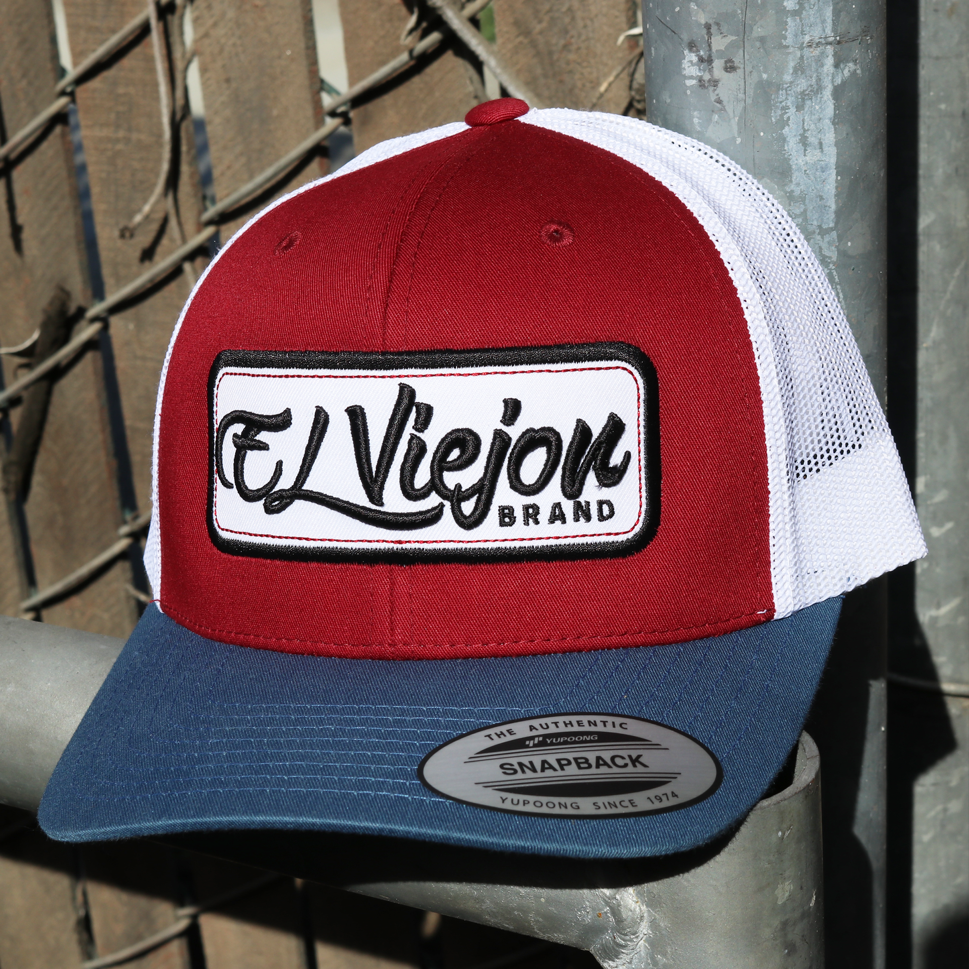 EVpatch Indigo/Maroon/White Yupoong Classic trucker hat with "El Viejon Brand" patch.