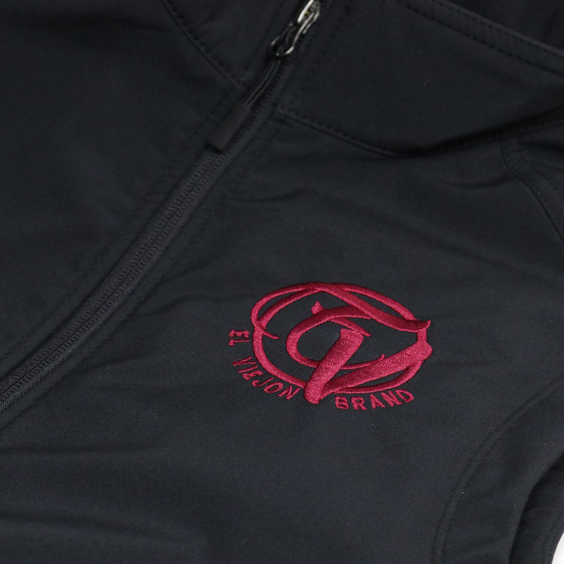 Black El Viejon Brand Vest with maroon embroidered logo, zip-through cadet collar, and water-resistant fabric.