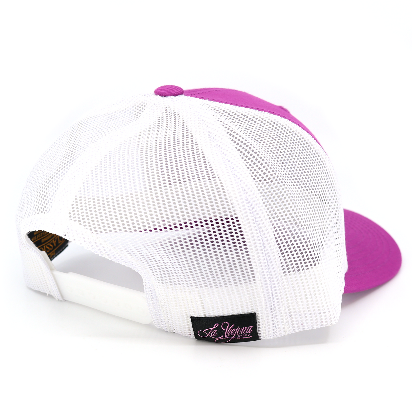 La Viejona magenta/white mesh Yupoong Classic trucker hat with pre-curved visor and adjustable snapback.