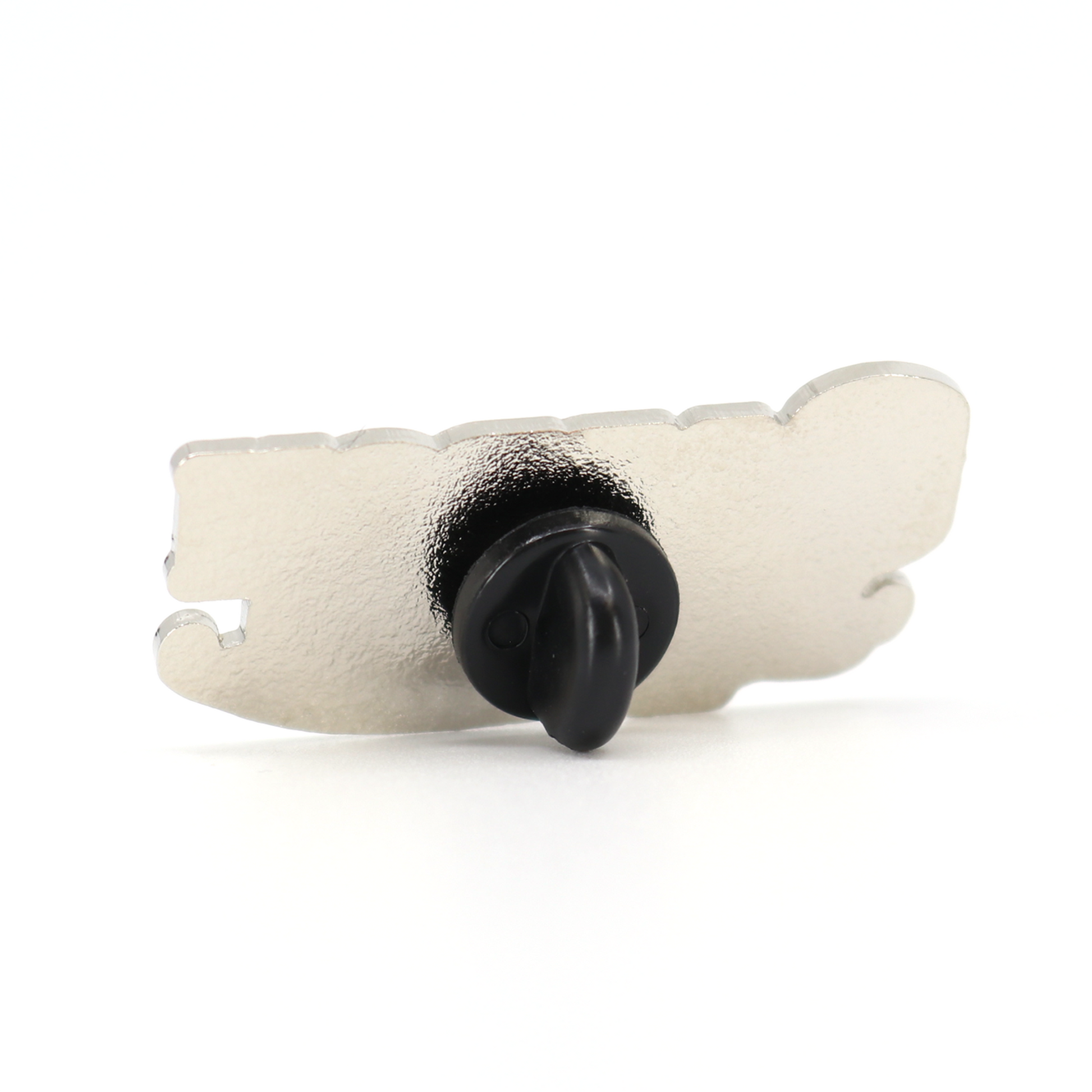 Silver "Cabron y Vago" pin with black rubber clutch, viewed from the back.