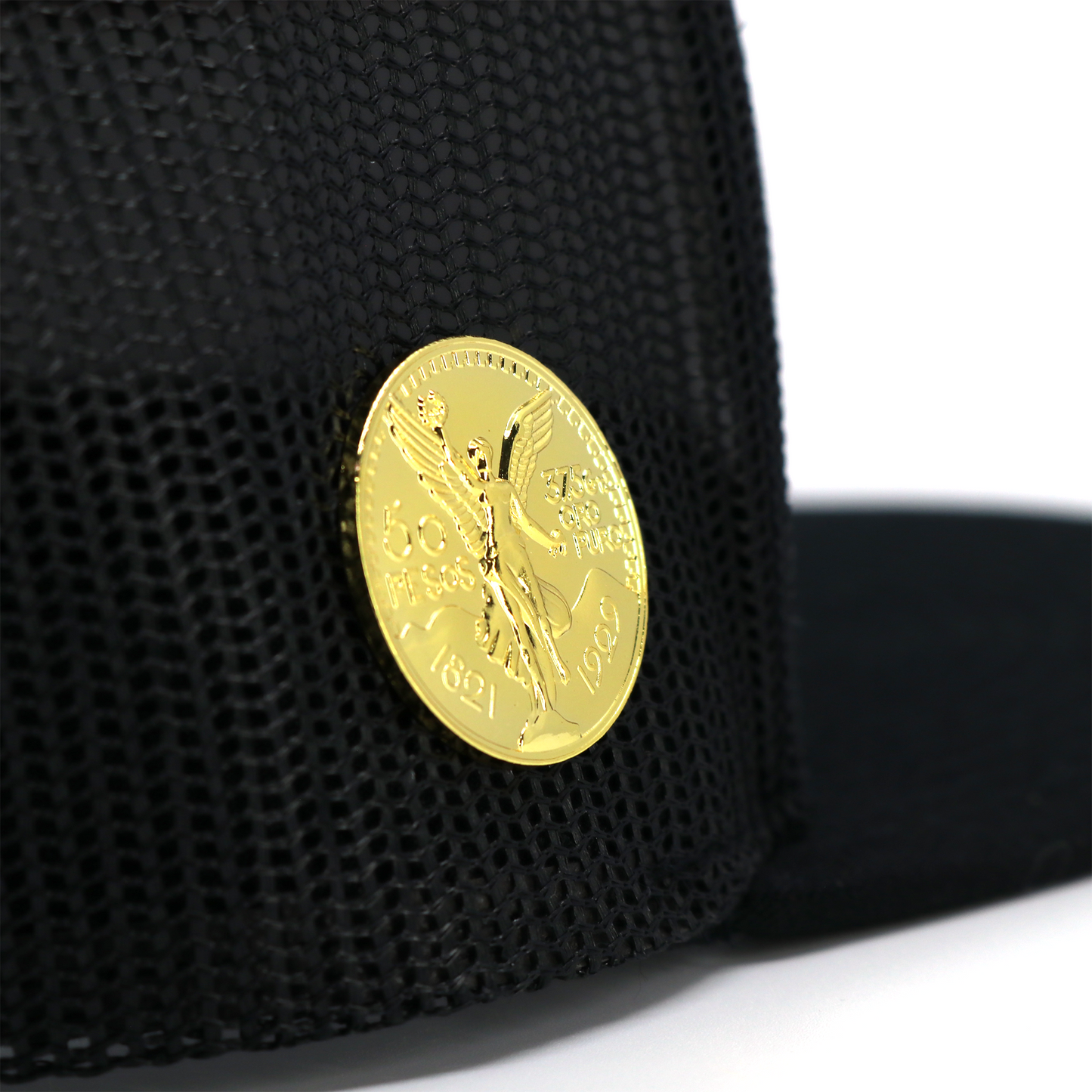El Cente gold-colored metal pin with winged angel design, attached to a black mesh cap.