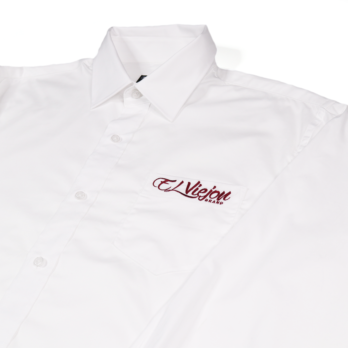 White long-sleeve dress shirt with straight collar, front pocket, and red "El Viejon Brand" embroidered logo.