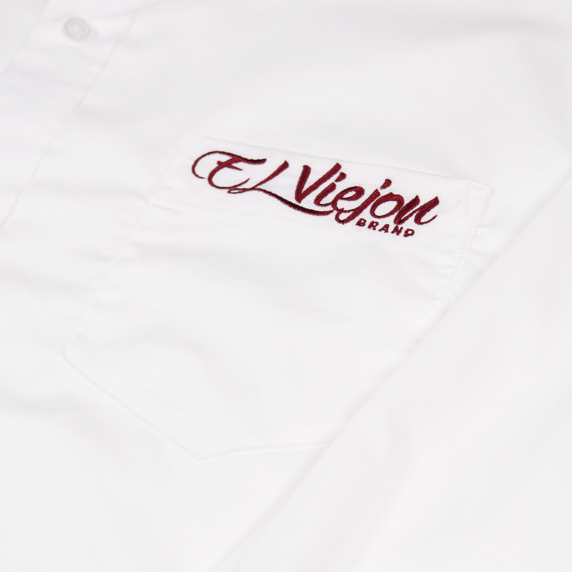 White cotton-span dress shirt with a front pocket and embroidered "El Viejon Brand" logo.
