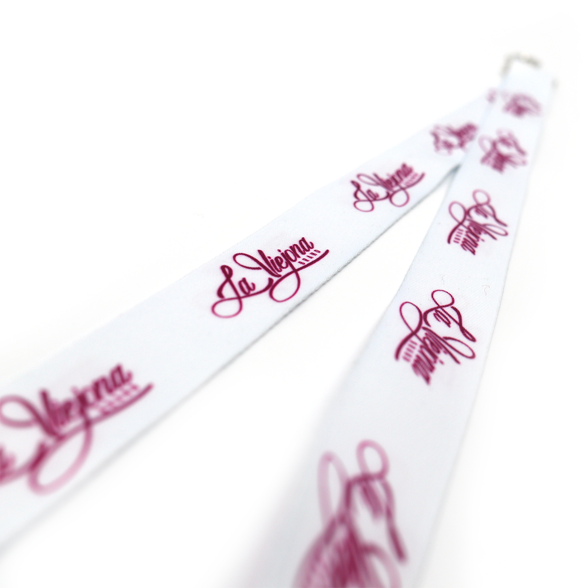 White La Viejona brand lanyard with repeating pink script logo, made of fabric with metal clip.