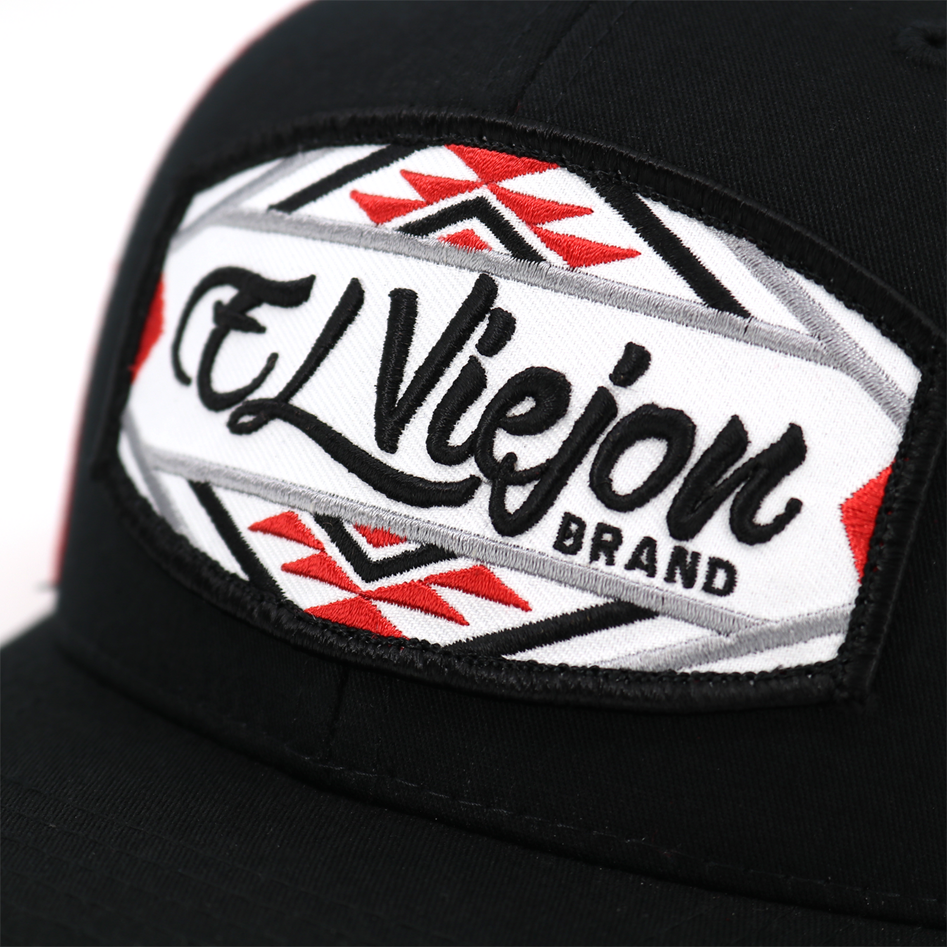 Black trucker hat with "EL ViejoN BRAND" patch, red and white Navajo-inspired pattern.