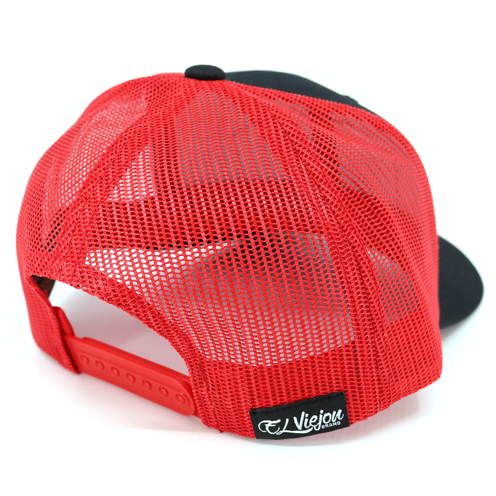 Navajo Black/Red Yupoong Classic trucker hat with red mesh back, adjustable snapback, and "Viejo Brands" tag.