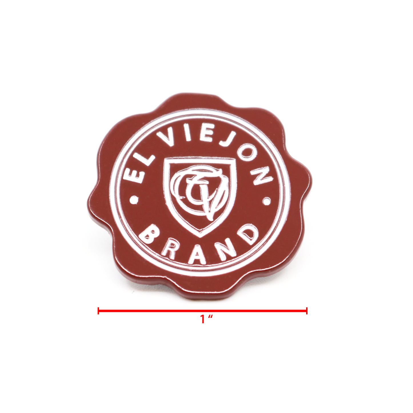 Sellito Rojo™ 1" enamel pin, dark red with white "EL VIEJON BRAND" text and shield logo.
