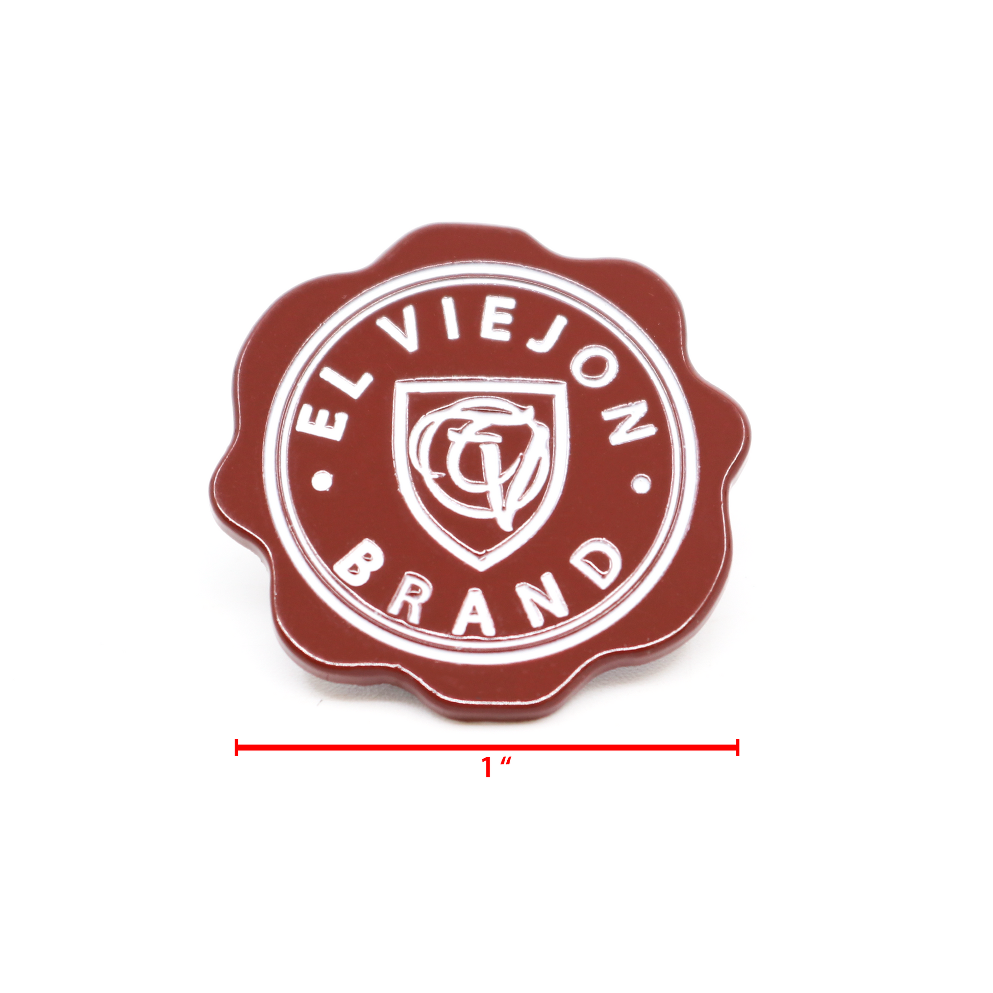 Sellito Rojo™ 1" enamel pin, dark red with white "EL VIEJON BRAND" text and shield logo.